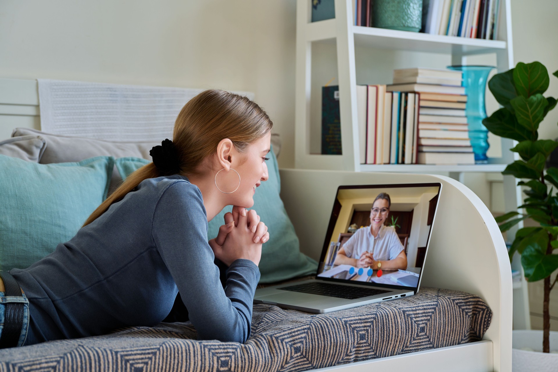 Teenager girl having online video conference therapy with psychologist